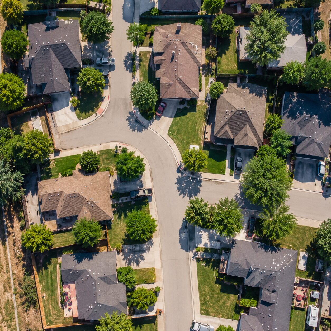 Property Investment for Beginners PDF cover image showing an aerial view of residential houses and neighborhoods representing real estate investment